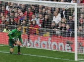 Van Der Sar can only look in wonder as the ball hits the net in his top left corner