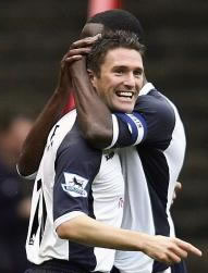 Robbie Keane celebrates his dramatic winning goal with skipper Ledley King, also on the score-sheet today