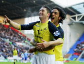 Robbie Keane celebrates his 8th minute goal in front of the Spurs section