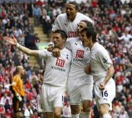 Robbie Keane (surrounded by Berbatov, Jenas and Bale) celebrates his second goal in front of the away stand