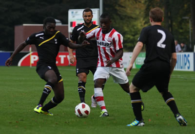 Spurs midfielder Laste Dombaxe challenages for the ball with John Bostock (facing) looking on