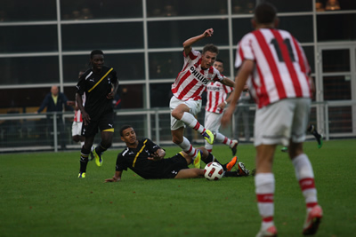 Kevin Stewart tries to halt a PSV advance with a sliding tackle