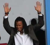 Edgar Davids - yet to be officially announced as a Spurs player - stands and acknowledges the support from an overjoyed army of Spurs fans