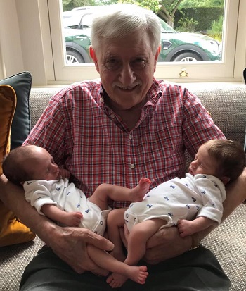 Norman Giller holding twin great grandchildren